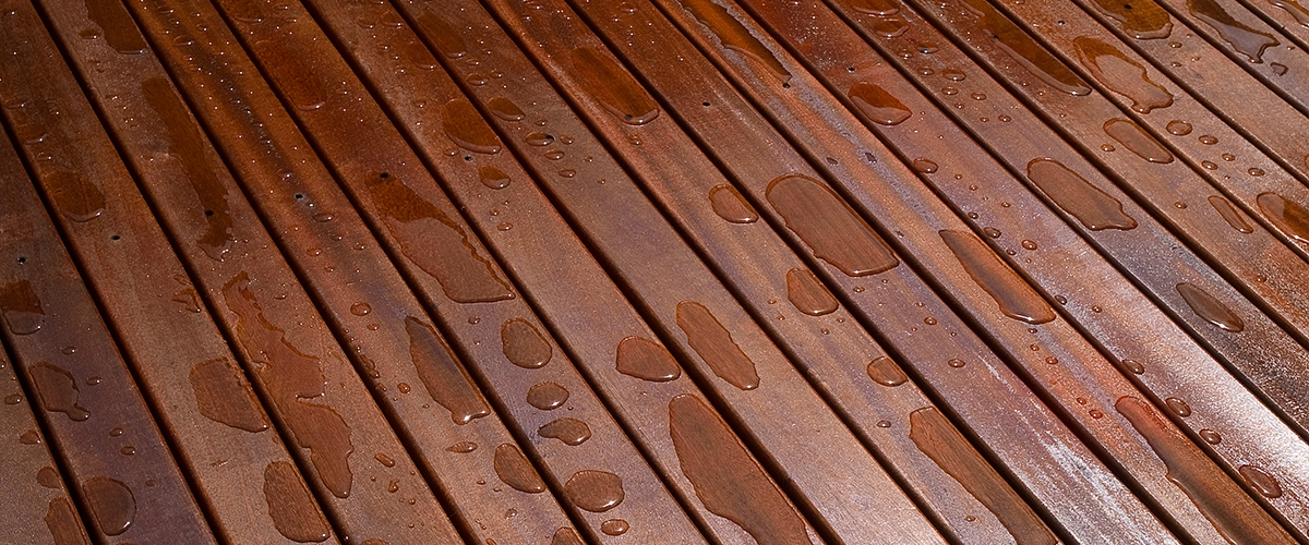 A mahogany wood on a deck with water droplets
