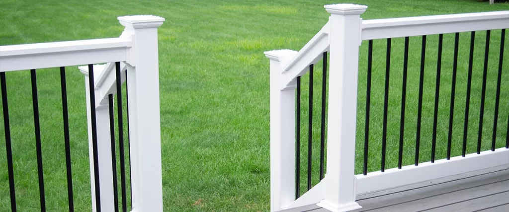A metal railing with white balustrade and posts
