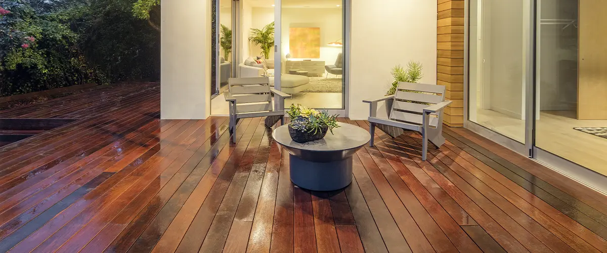 Deck accessories on a hardwood decking with two small chairs and a small round table