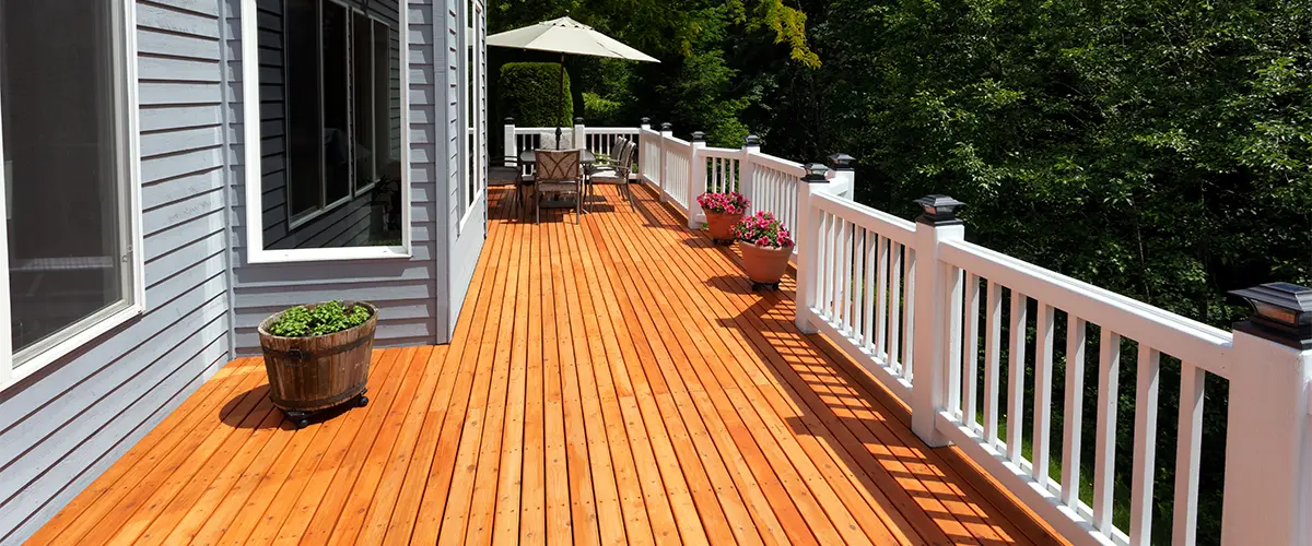 A deck building in Severna Park MD with cedar decking and white railing