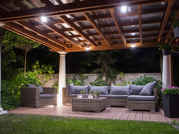 A pergola with lights on a composite deck