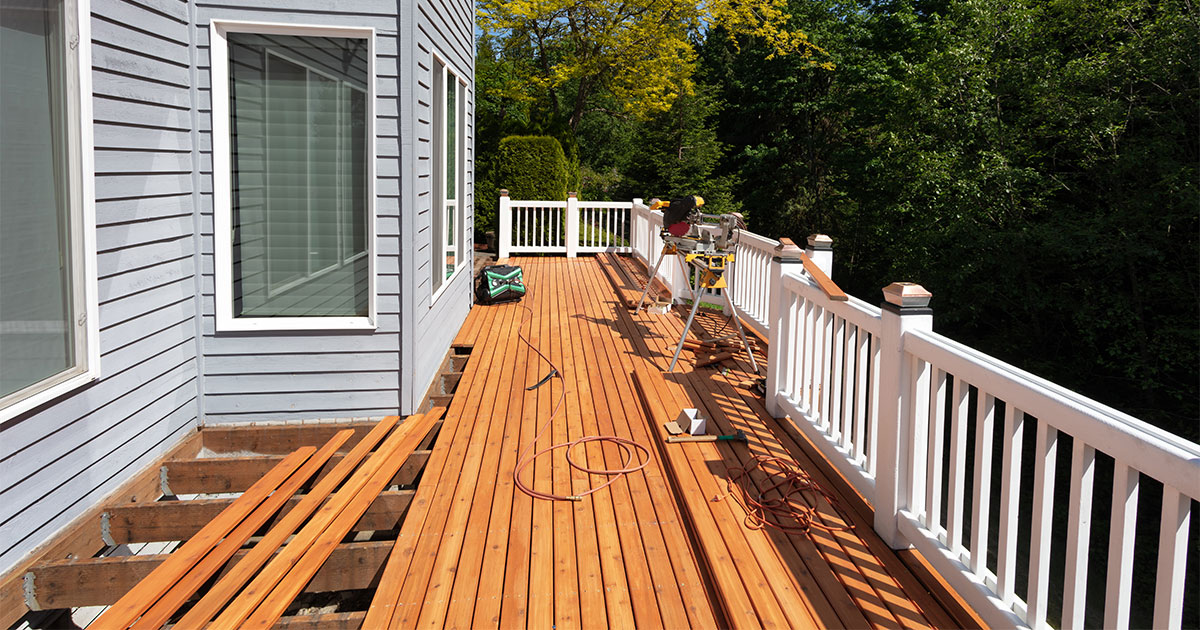 Cedar decking repair in Severna Park with white railings