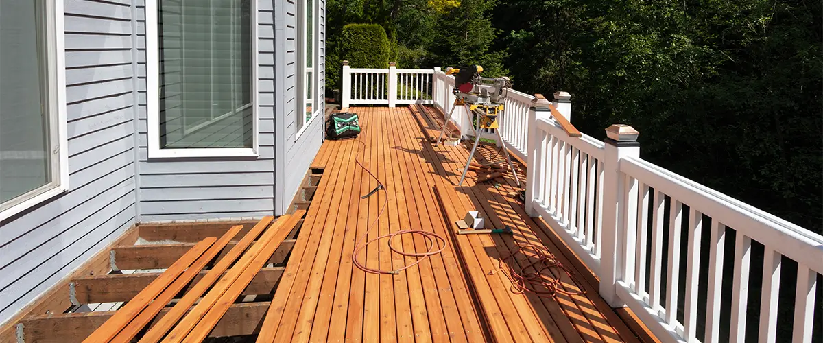 Cedar decking repair with white railings