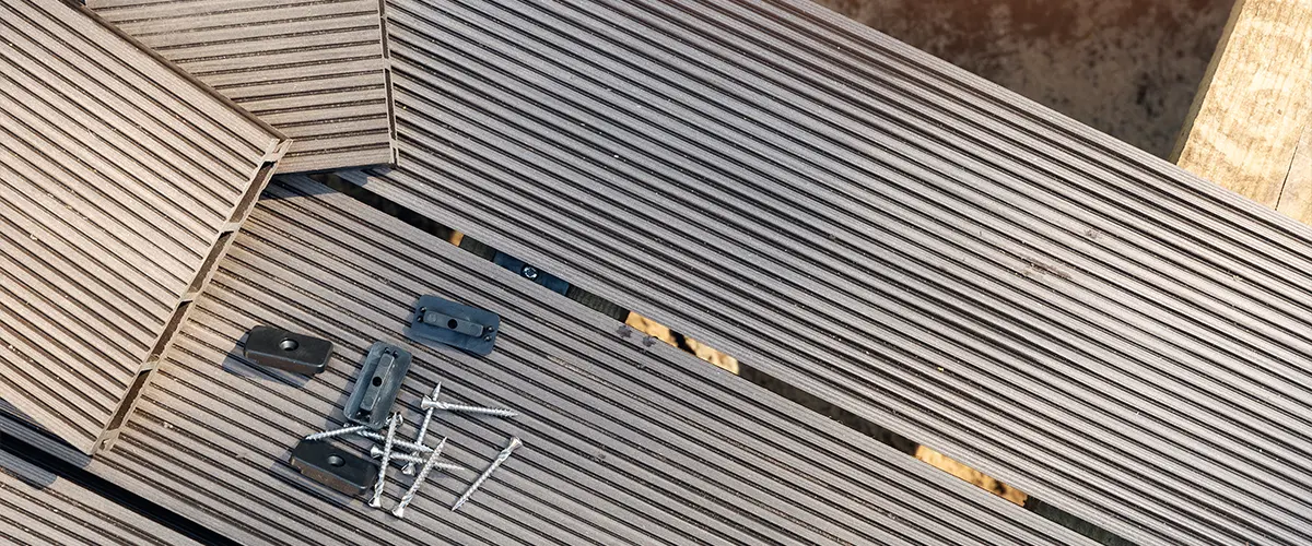 Composite decking repair with black fasteners and brackets