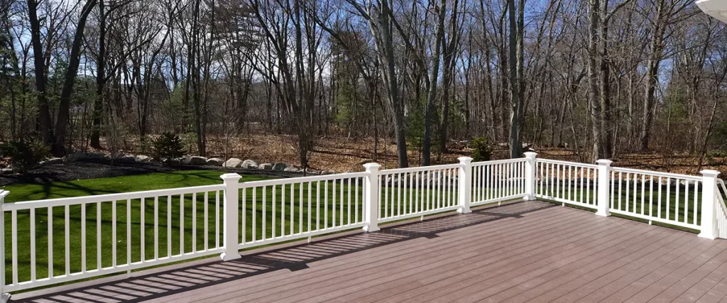 White railings on wood deck stained beige