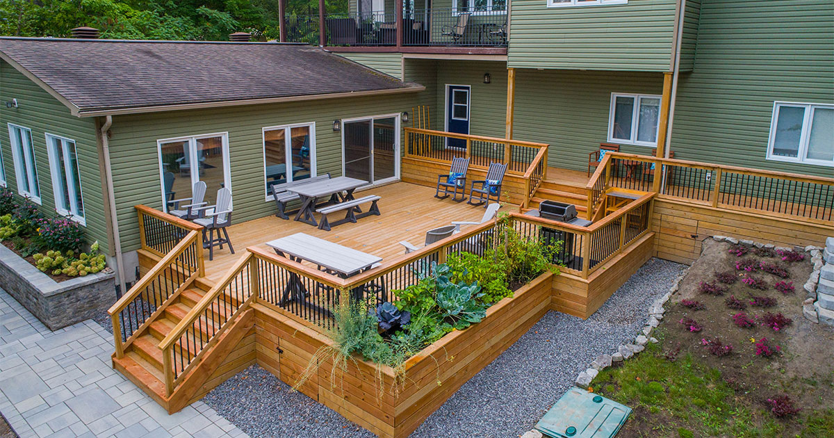 Large wood decking with railing and outdoor furniture