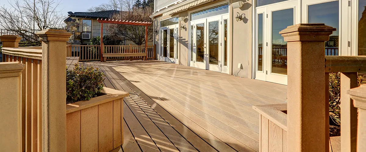 Composite decking with composite railing on a home with large glass doors