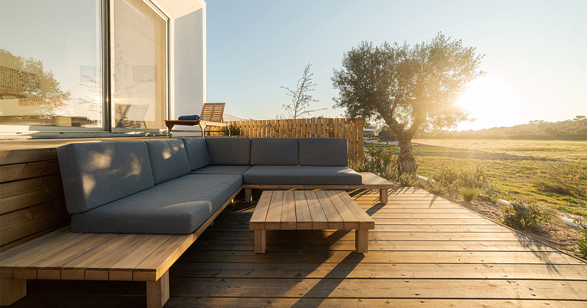 A ground-level wood deck with built-in furniture