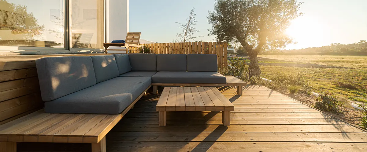 A ground-level wood deck with built-in furniture