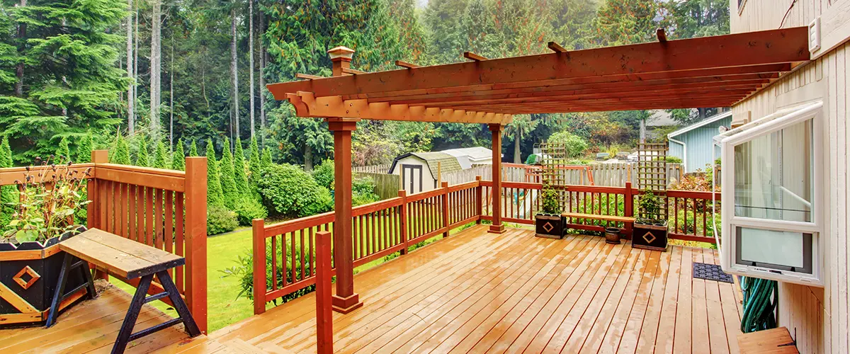 wooden deck covered with wooden pergola