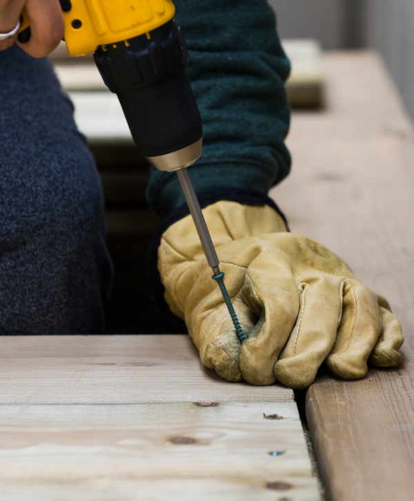 image of a man repairing a deck for deck repairing companies in Severna Park