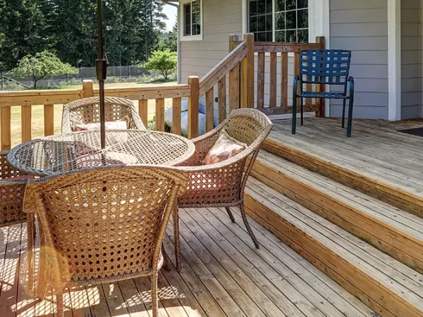 Pressure-treated deck with wood railing and outdoor furniture